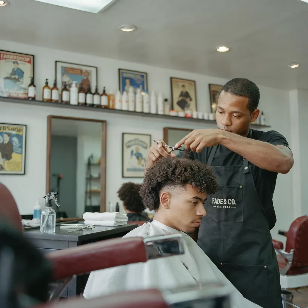 barber cutting curly hair dry for accurate length