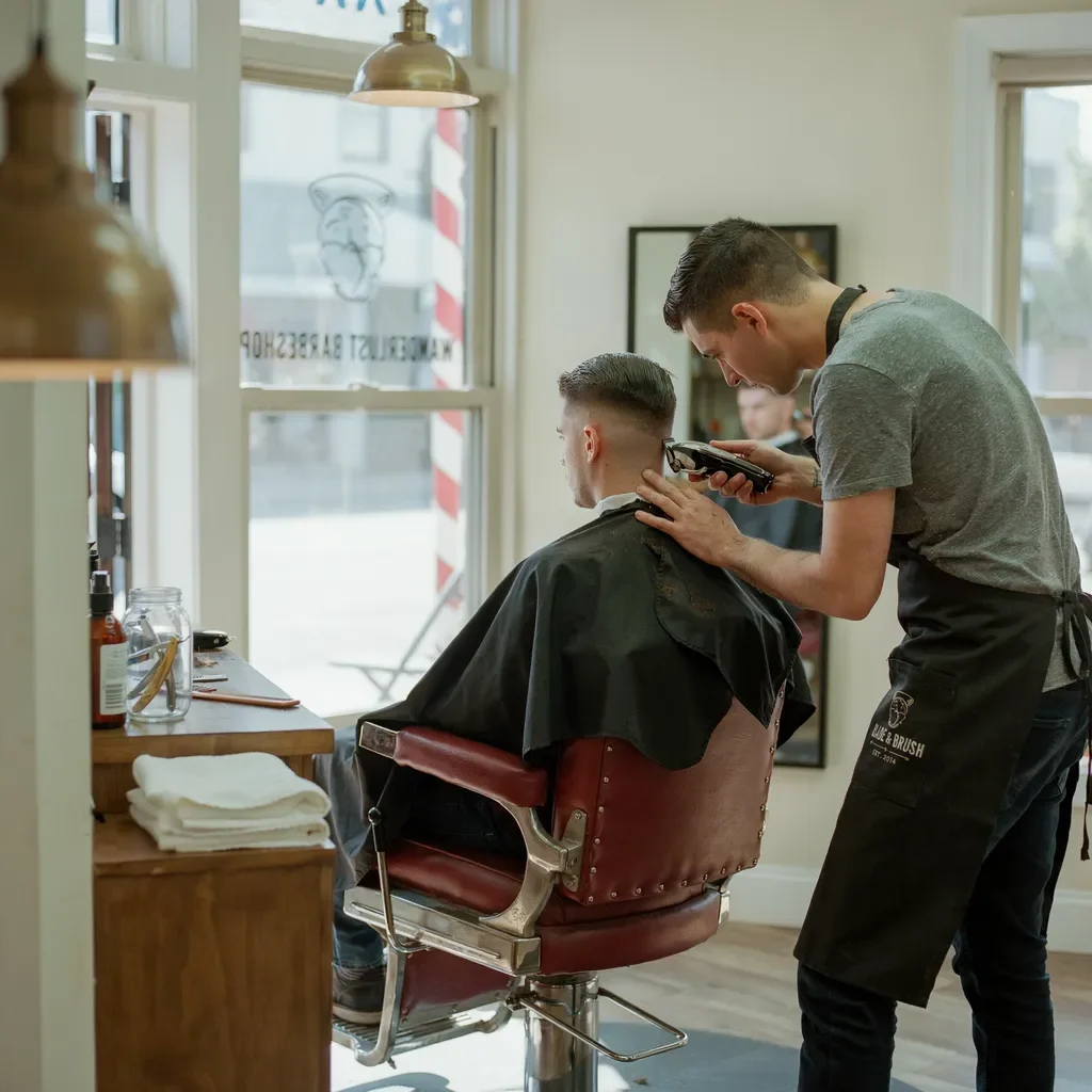 barber trimming a fade line to keep it sharp