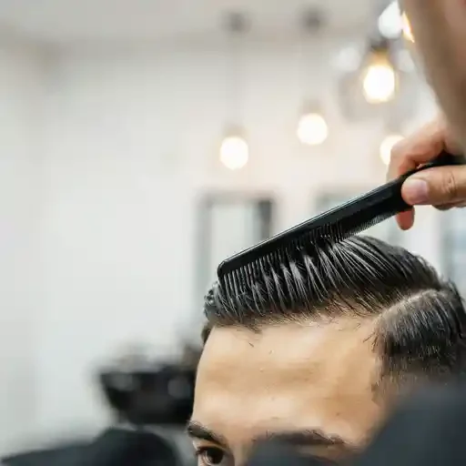 combing a brush back style into direction
