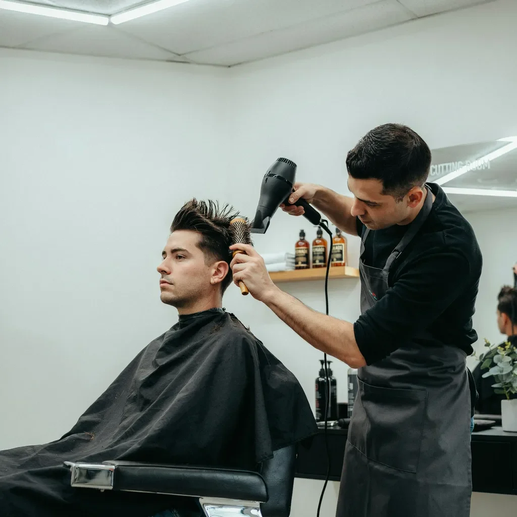 blow drying a quiff with a round brush