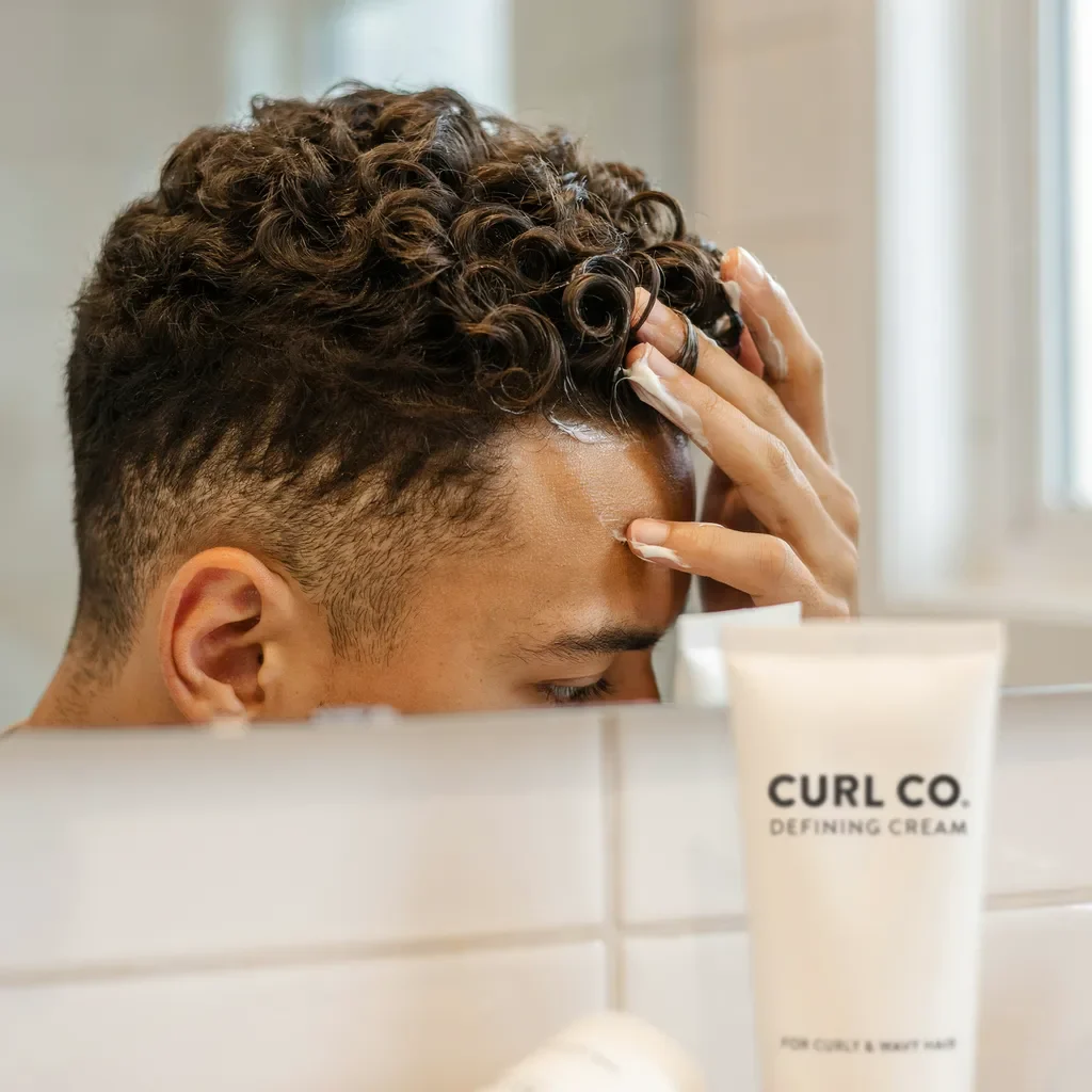 curl defining cream applied to curly hair