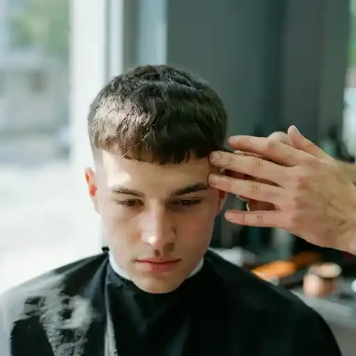 finger styling a forward fringe on a french crop