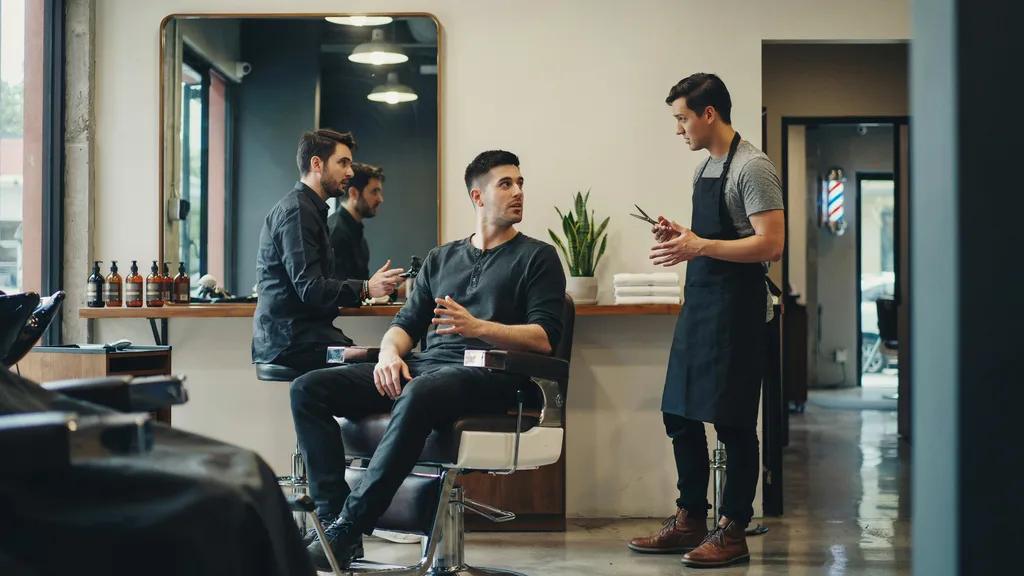 Client discussing his haircut with a barber during a consultation
