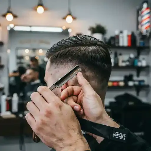 barber shaving a thin hard part line