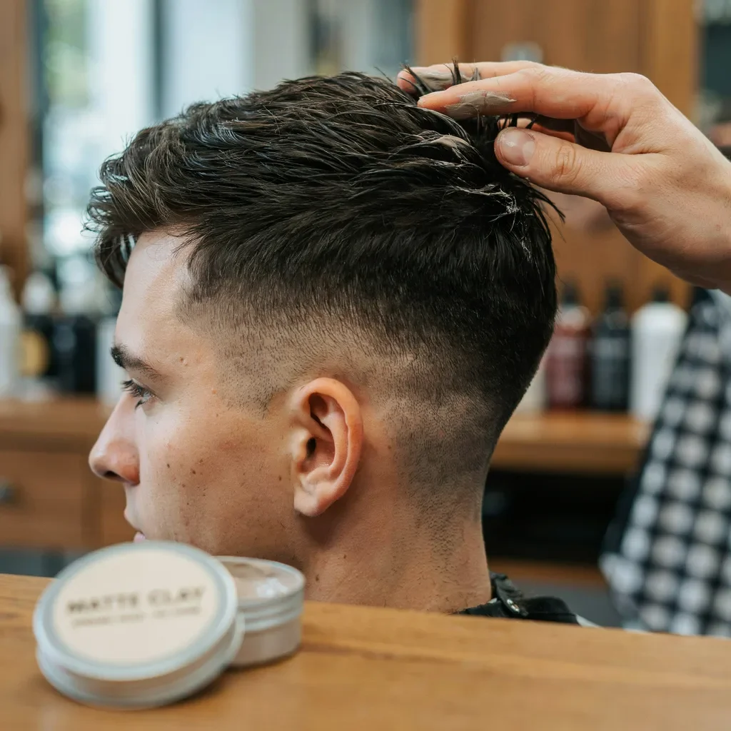 matte clay being applied to short textured hair