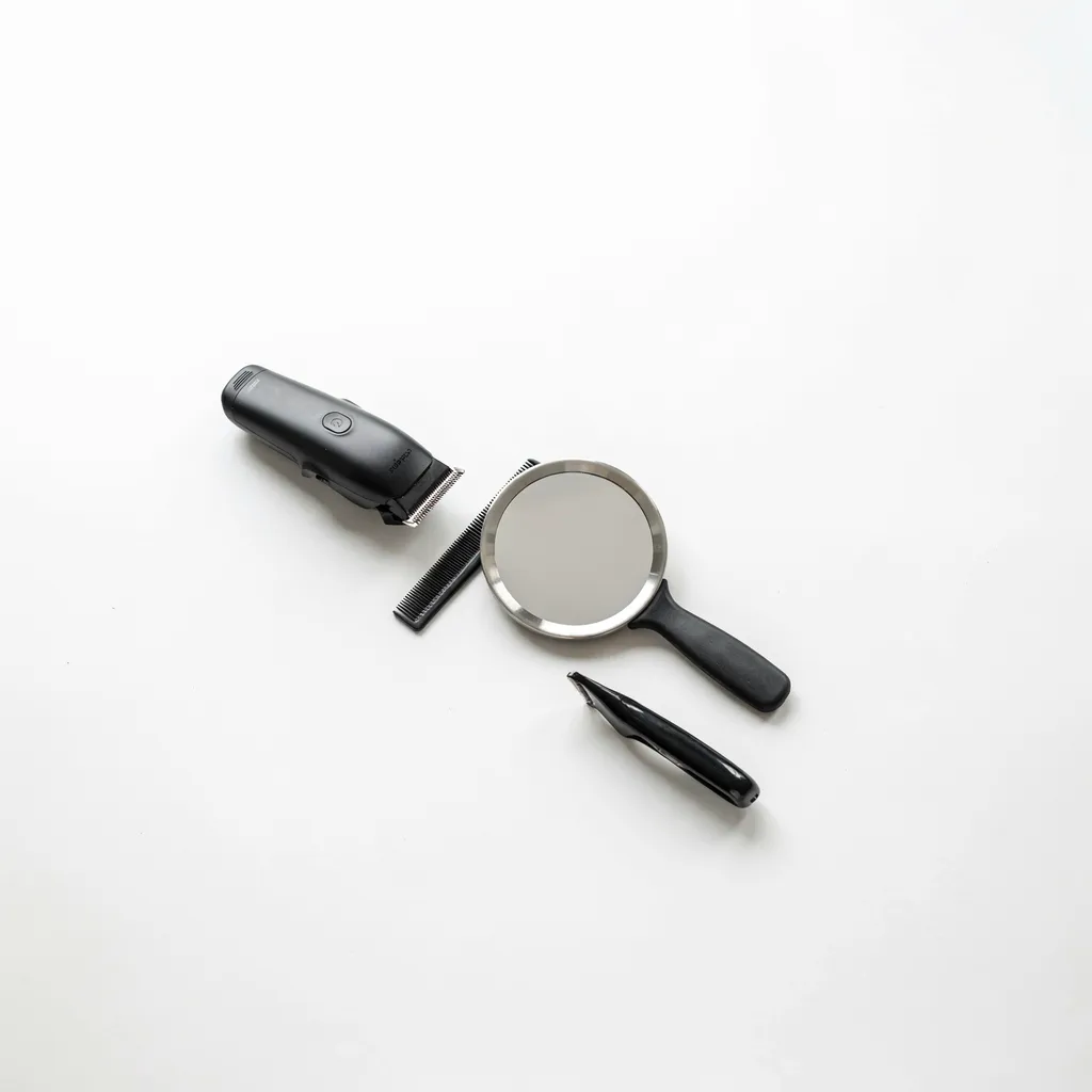 Minimal starter haircut kit with clippers, trimmer, and hand mirror