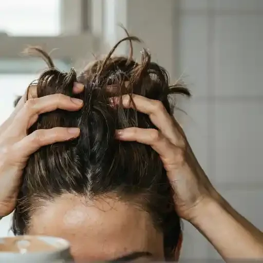 finger styling a messy textured top