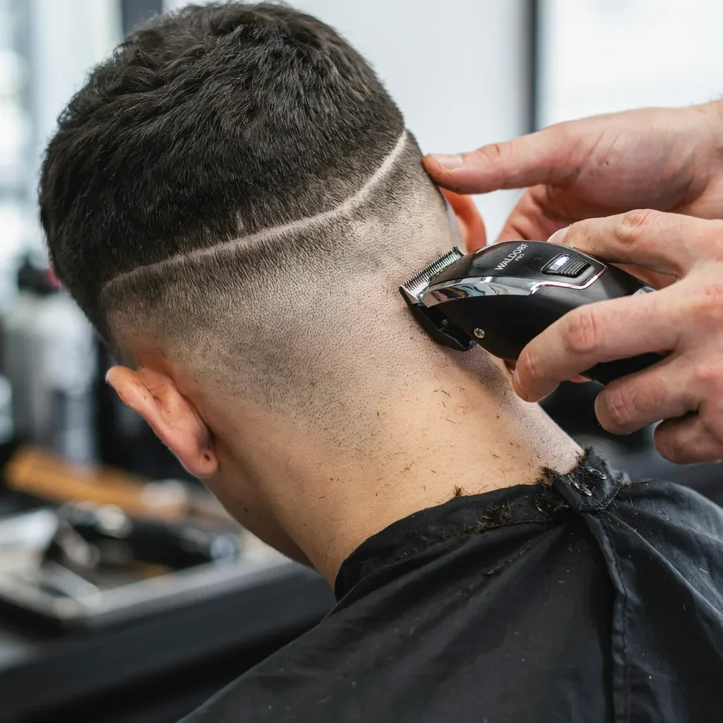 trimming a neckline with a handheld trimmer