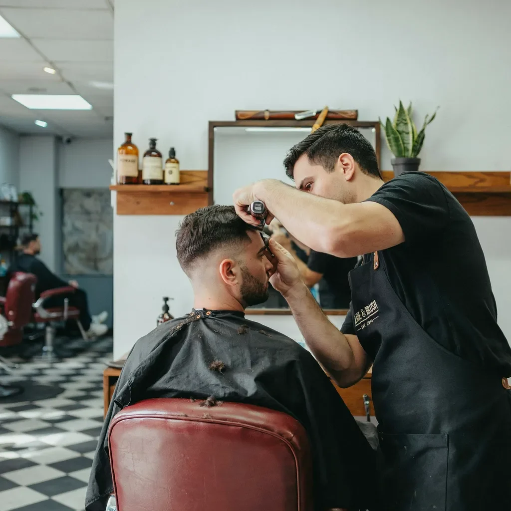 barber creating a bolder undercut inspired fade