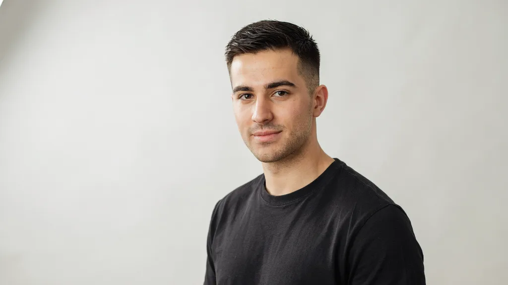 Confident young man with a fresh clean mid fade haircut